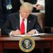 U.S. president signing an immigration-related executive order during a public event