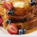 Golden French toast stack with butter, maple syrup and fresh berries