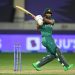 Fakhar Zaman of Pakistan batting in a cricket match, playing a powerful shot with stumps visible behind him on a stadium field.
