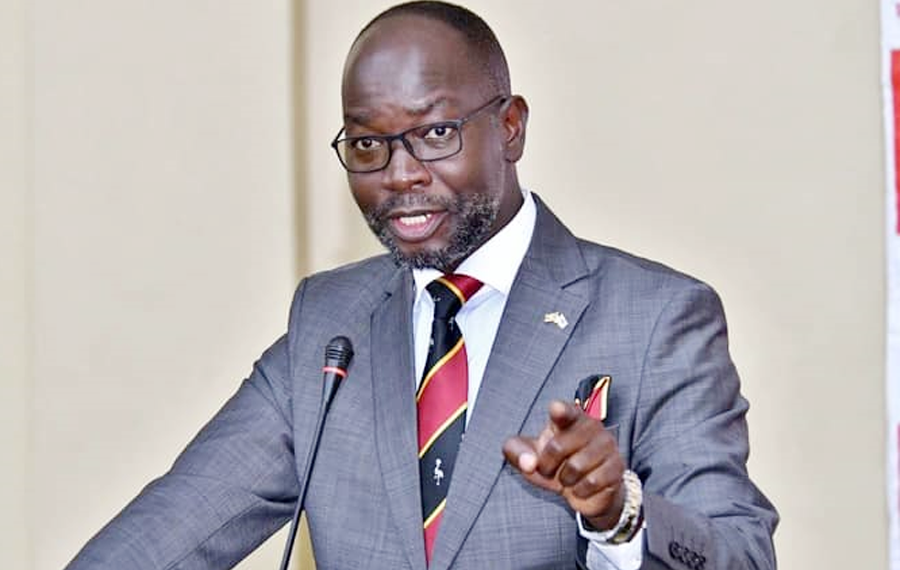 "Hon. Denis Hamson Obua, Government Chief Whip, speaking at a public event in Uganda"