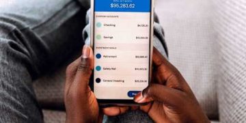 New immigrant in the USA using a mobile banking app to manage money and open a bank account.