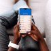 New immigrant in the USA using a mobile banking app to manage money and open a bank account.