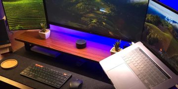 Modern home office setup with laptop and ultra‑wide monitors on a wooden desk for making money online from home