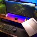 Modern home office setup with laptop and ultra‑wide monitors on a wooden desk for making money online from home