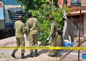 Security personnel at Ggaba nursery school crime scene, Kampala, after the 2026 massacre"