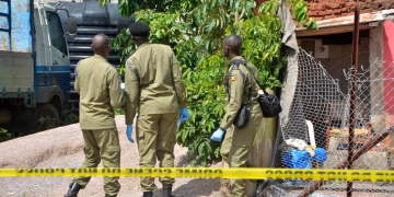 Security personnel at Ggaba nursery school crime scene, Kampala, after the 2026 massacre"