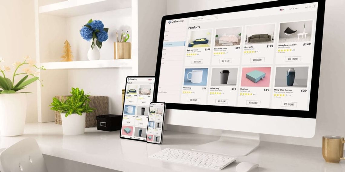 Modern home office desk with computer, tablet and smartphone showing an online store with small business products.