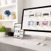 Modern home office desk with computer, tablet and smartphone showing an online store with small business products.