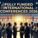 alt="Diverse group of young professionals networking at a luxury conference hall with a stunning city skyline at sunset, representing fully funded international conferences 2026 with complete sponsorship"