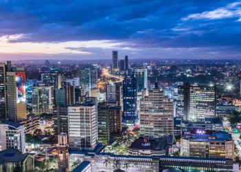 Vibrant modern city skyline at dusk with illuminated skyscrapers representing opportunity and success for Africans relocating abroad in 2026