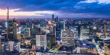 Vibrant modern city skyline at dusk with illuminated skyscrapers representing opportunity and success for Africans relocating abroad in 2026