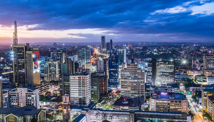 Vibrant modern city skyline at dusk with illuminated skyscrapers representing opportunity and success for Africans relocating abroad in 2026