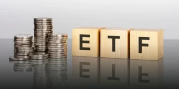 ETF investment concept with stacked coins representing high-yield passive income investments in 2026