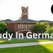 alt="Beautiful historic university campus in Germany with clock tower and green lawns, ideal for international students in 2026"