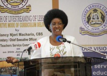 "Dr. Nancy Njeri Macharia, TSC Kenya CEO, speaking at a podium during the launch of livestreaming lessons for alternative curriculum delivery."