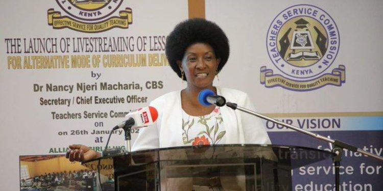 "Dr. Nancy Njeri Macharia, TSC Kenya CEO, speaking at a podium during the launch of livestreaming lessons for alternative curriculum delivery."