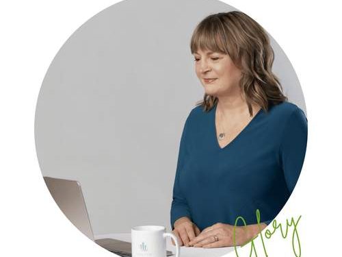 “Financial planner sitting at a desk with a laptop and coffee mug, reviewing a dividend portfolio for long‑term passive income.