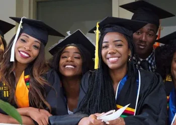 alt="Happy African graduates in caps and gowns celebrating scholarship success and academic achievement"