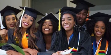 alt="Happy African graduates in caps and gowns celebrating scholarship success and academic achievement"