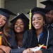 alt="Happy African graduates in caps and gowns celebrating scholarship success and academic achievement"