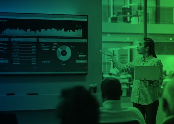 Businesswoman presenting futuristic financial dashboard with AI and data analytics in a modern office, representing the future of global capital markets