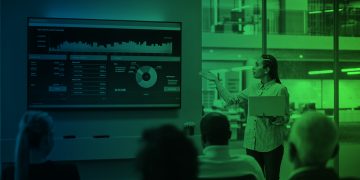 Businesswoman presenting futuristic financial dashboard with AI and data analytics in a modern office, representing the future of global capital markets