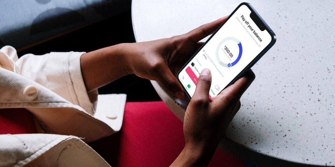 Person using a mobile banking app on a smartphone to manage digital finances and payments.