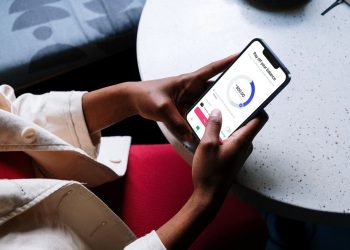 Person using a mobile banking app on a smartphone to manage digital finances and payments.