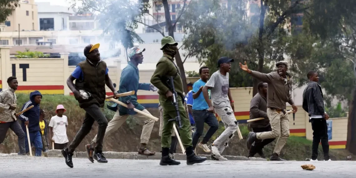 Kenya goonism – protesters and a police officer clash on the streets amid tear gas and political unrest in Kenya