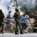Kenya goonism – protesters and a police officer clash on the streets amid tear gas and political unrest in Kenya