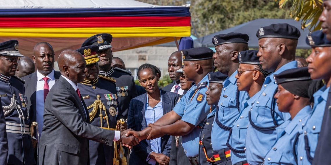President William Ruto shakes hands with police officers in the new light blue uniform during the unveiling ceremony at Kiganjo Police Training College