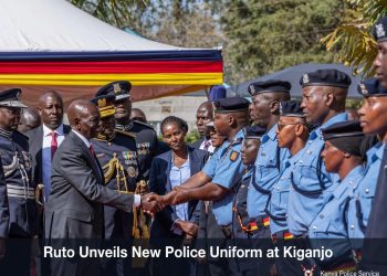 President William Ruto shakes hands with police officers in the new light blue uniform during the unveiling ceremony at Kiganjo Police Training College